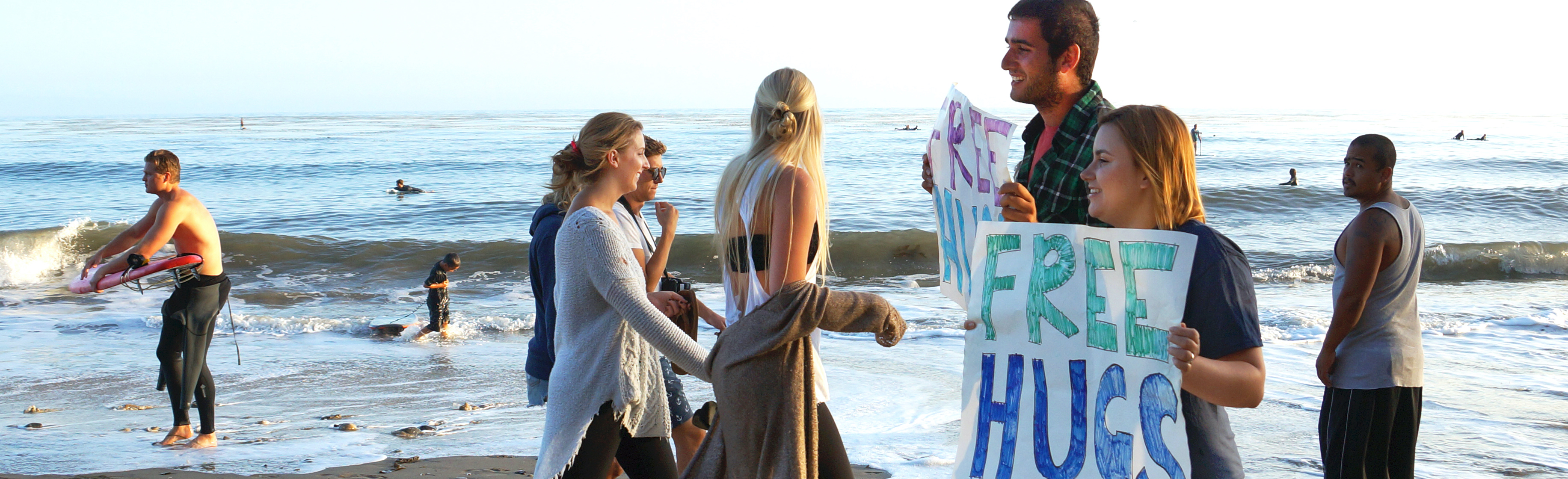 Image of people holding free hugs sign